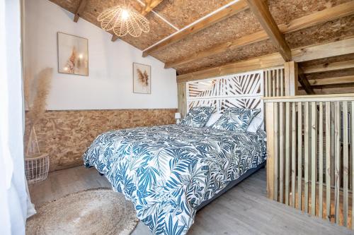 a bedroom with a bed with blue and white sheets at Ti chalet toto in Saint-Louis