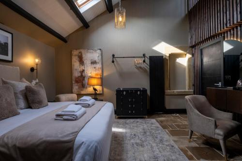 a bedroom with a bed with towels on it at Derwent Manor Boutique Hotel in Consett