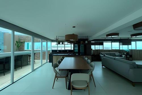 a living room with a table and chairs at Studios Premium RN in Maceió