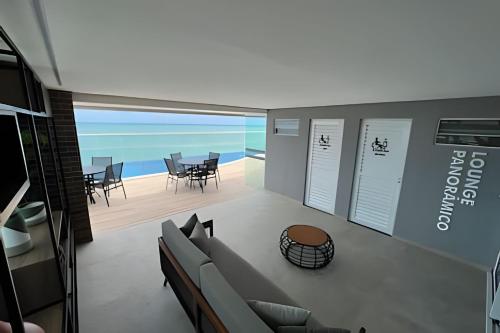 a living room with a view of the ocean at Studios Premium RN in Maceió