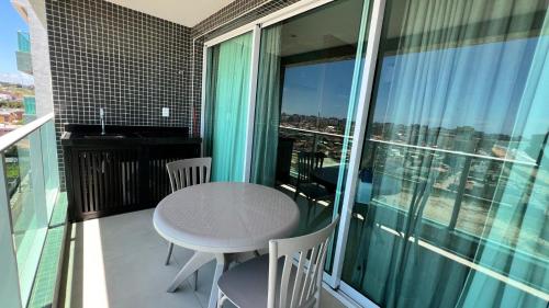 a table and chairs on a balcony with a view at Studios Premium RN in Maceió