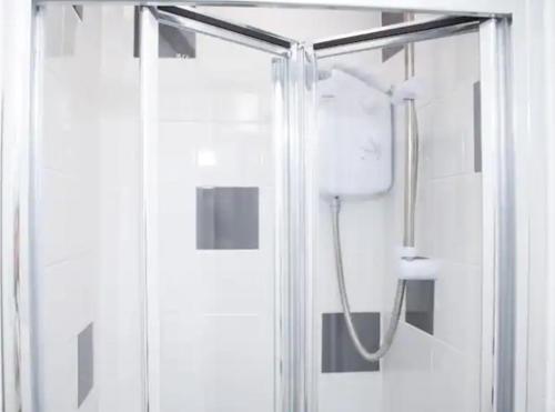 a shower in a bathroom with a glass door at Central Bliss 2BD Apt Near Transport Links in Liverpool