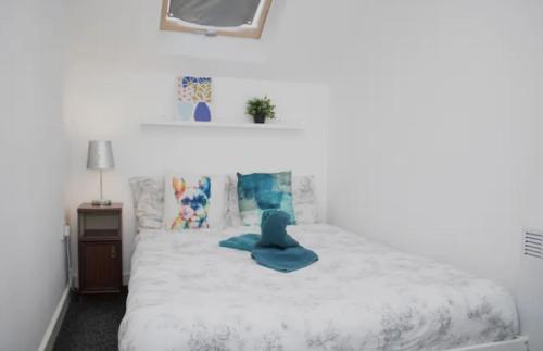 a bedroom with a bed with a blue object on it at Central Bliss 2BD Apt Near Transport Links in Liverpool