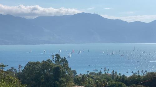 a large body of water with sail boats in it at Casas No Centro Histórico (vila) in Ilhabela