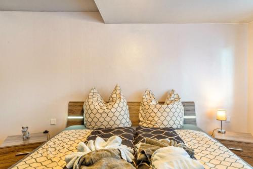 a bedroom with a bed with pillows on it at Ferienwohnung Schumacher in Bad Herrenalb