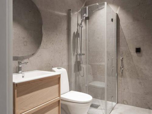 a bathroom with a shower and a toilet and a sink at Are Alpine Escape Ski-in Ski-out Apt in Åre
