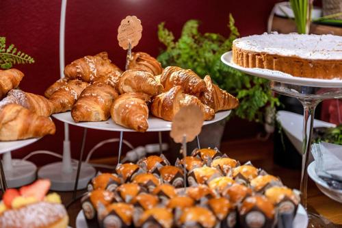 a display of different types of pastries and pies at Domino Suite Hotel & Residence in Lido di Jesolo
