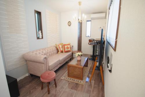 a living room with a couch and a table at QiQi Serenity Tokyo Exclusive New 3-Story Home, 14min to Skytree, Asakusa Area in Tokyo