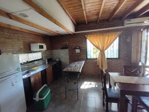 a kitchen with a table and a counter top at Hanuja Payé in General Belgrano