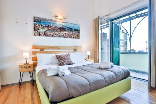 ein Schlafzimmer mit einem großen Bett und einem großen Fenster in der Unterkunft Terrazza Concordia Amazing View in Neapel