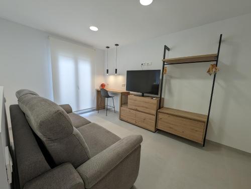 a living room with a couch and a television at Gran Hotel Toledo in Onda