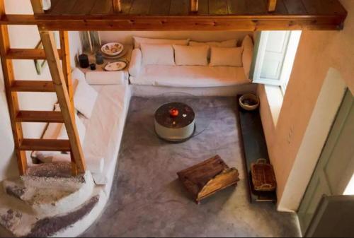 an overhead view of a living room in a tiny house at Hanging at the top of the world in Oia