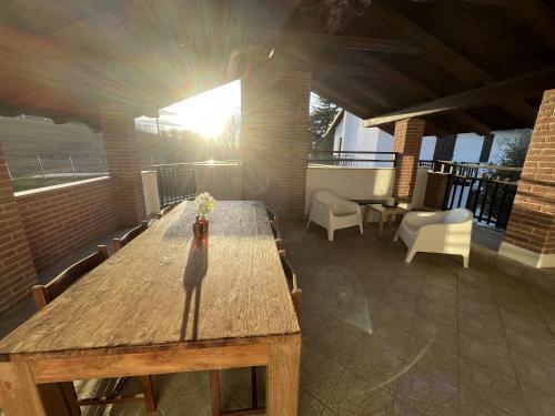 a large wooden table in a room with chairs at Case Vista Alta Langa, Appartement Bella Vista in Cravanzana