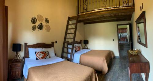 a bedroom with two bunk beds and a ladder at Cabaña No.2 Puerta del Bosque Mazamitla. in Mazamitla