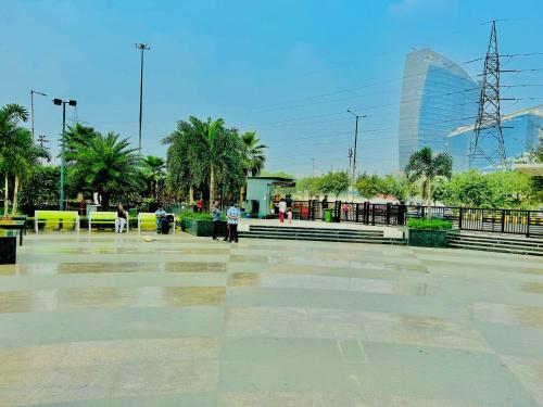 a parking lot with a glass building in the background at THE HONEY HOMES in Noida