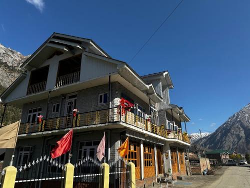 - un bâtiment avec des drapeaux sur le balcon dans l'établissement D’SHIEKHS RESORT GUREZ, à Kanzalwan