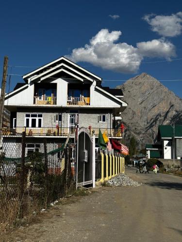 a house on the side of a road with a fence at D’SHIEKHS RESORT GUREZ in Kanzalwan
