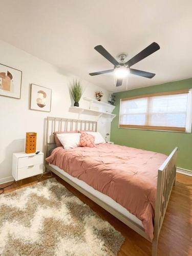 a bedroom with a bed and a ceiling fan at Hidden GEM W1 king bed &2 queens in Winston-Salem