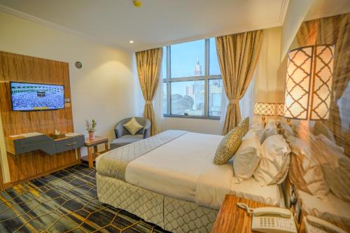 a hotel room with a bed and a television at Lamar Ajyad First Hotel Tower B in Mecca