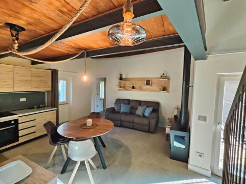 a living room with a table and a couch at Volaterrae Deluxe Loft with garden in Volterra
