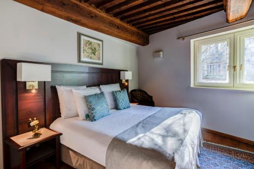 a bedroom with a large bed and a window at Villa Florentine in Lyon