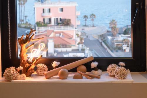 a window with a view of the ocean and some food at Hotel Parigi & Spa in Bordighera