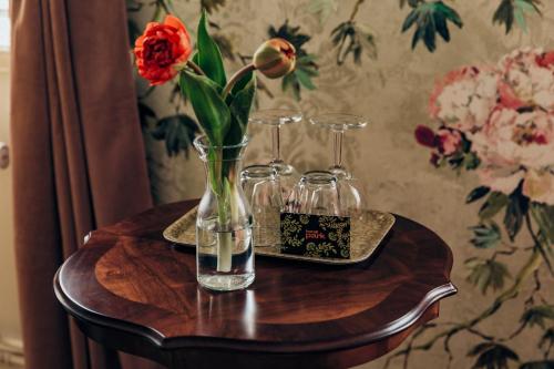 a vase with a flower in it on a table at Hotell Park in Västervik
