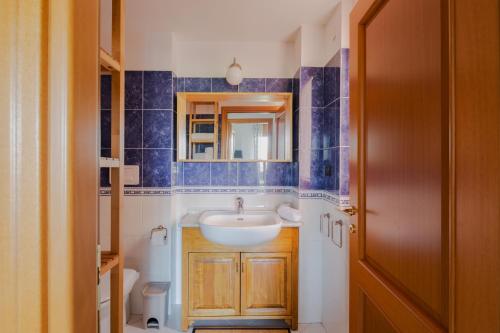 W łazience znajduje się umywalka i lustro. w obiekcie EUR Moravia Attico panoramico con terrazzo, fino a 5 ospiti w Rzymie
