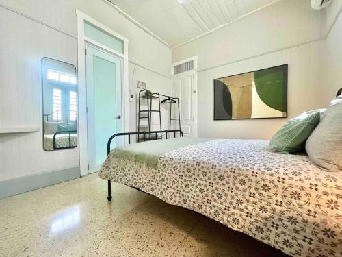 1 dormitorio con 1 cama en una habitación con ventana en New! Antique House at Ponce, en Ponce