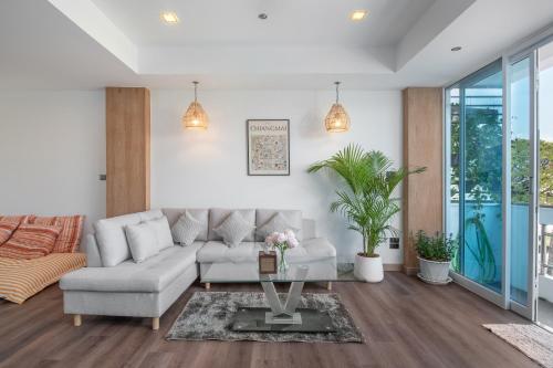 a living room with a couch and a table at Baan Khun Ree in Chiang Mai