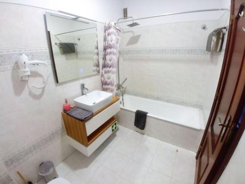 a bathroom with a sink and a bath tub at Be Local - Apartment with 3 bedroom near Oriente Station in Lisbon in Lisbon