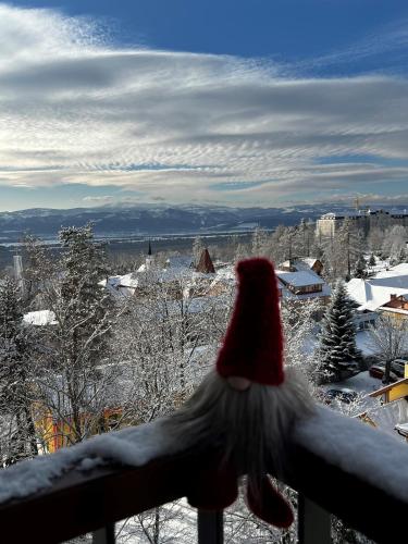 a santa hat on top of a balcony with snow at KUBO TATRY - Starý Smokovec in Smokovce