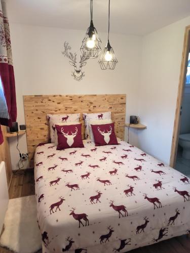 a bedroom with a bed with a comforter with horses on it at La sapinette in La Bâthie