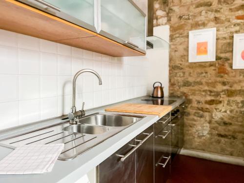 a kitchen with a sink and a counter at Lovely Apartment near Piazza della Signoria in Florence