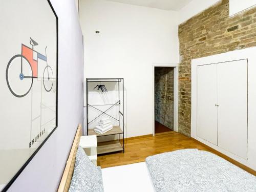 a room with white walls and a brick wall at Lovely Apartment near Piazza della Signoria in Florence