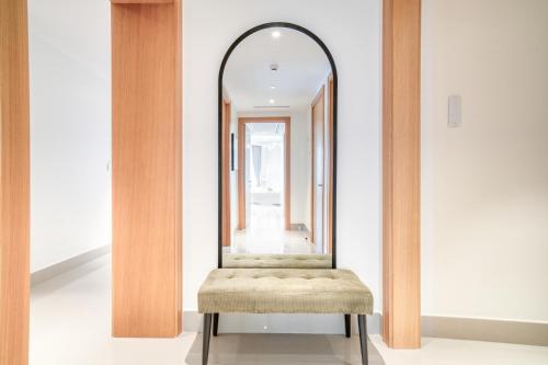 a dressing room with a stool and a mirror at Downtown Luxury - Stunning Burj Khalifa & Sea View - 5 Minutes Walk to Dubai Mall in Dubai