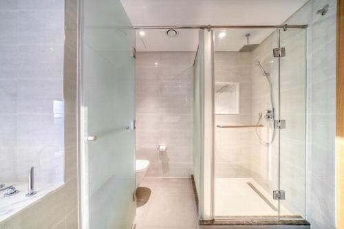 a bathroom with a shower and a toilet at Downtown Luxury - Stunning Burj Khalifa & Sea View - 5 Minutes Walk to Dubai Mall in Dubai