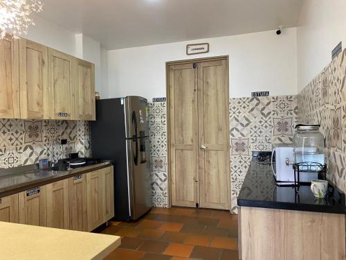 a kitchen with a refrigerator and wooden cabinets at hotel Atabal 
