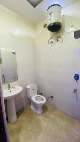 a bathroom with a toilet and a sink at SBV Homes in Kharar