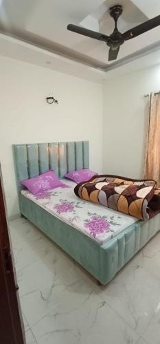 a bed in a room with a ceiling at SBV Homes in Kharar
