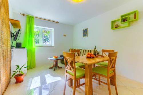 a kitchen and dining room with a wooden table and chairs at Apartments Filipovic, 3 min walk to the beach in Split