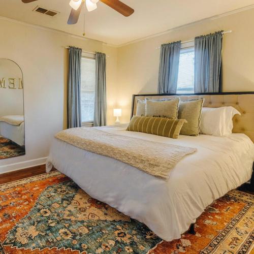 a bedroom with a large bed with blue curtains at Historic Revival King Bed Liberty Bowl Memphis 893 in Memphis