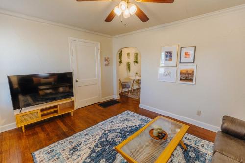 a living room with a large flat screen tv at Historic Revival King Bed Liberty Bowl Memphis 893 in Memphis