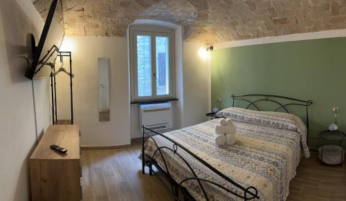 a bedroom with a bed and a table and a window at Guest House il Il Podestà in Garbagna
