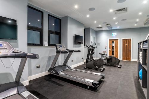 a gym with two treadmills and two exercise bikes at Sandman Signature Aberdeen Hotel & Spa in Aberdeen