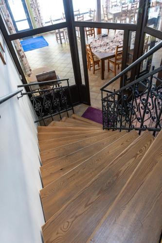 a stairway with chairs and a table in a building at Penzion U rybníka in Šumperk