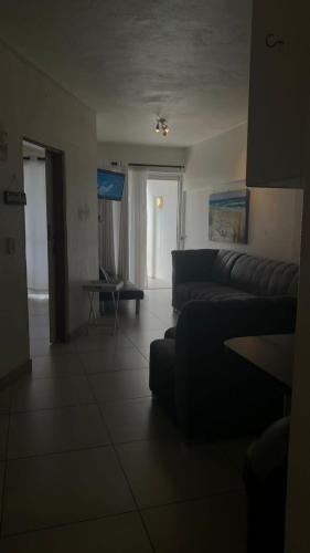 a living room with a couch and a table at Toti Cabana 58 in Amanzimtoti