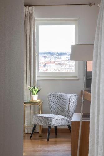 a room with a chair and a window at Villa Florentine in Lyon