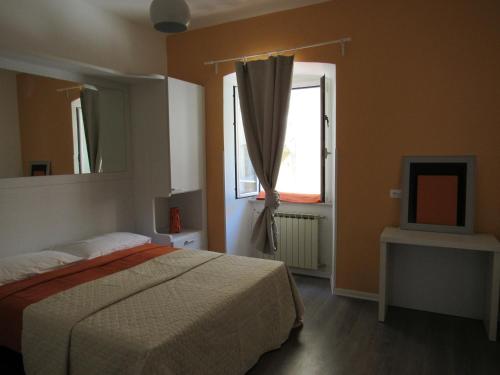 a bedroom with a bed and a window and a television at Smart Rooms in Trieste