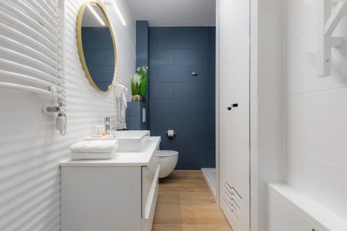 a bathroom with a white sink and a mirror at Pobierowo Beach Baltic Apartments by Renters in Pobierowo